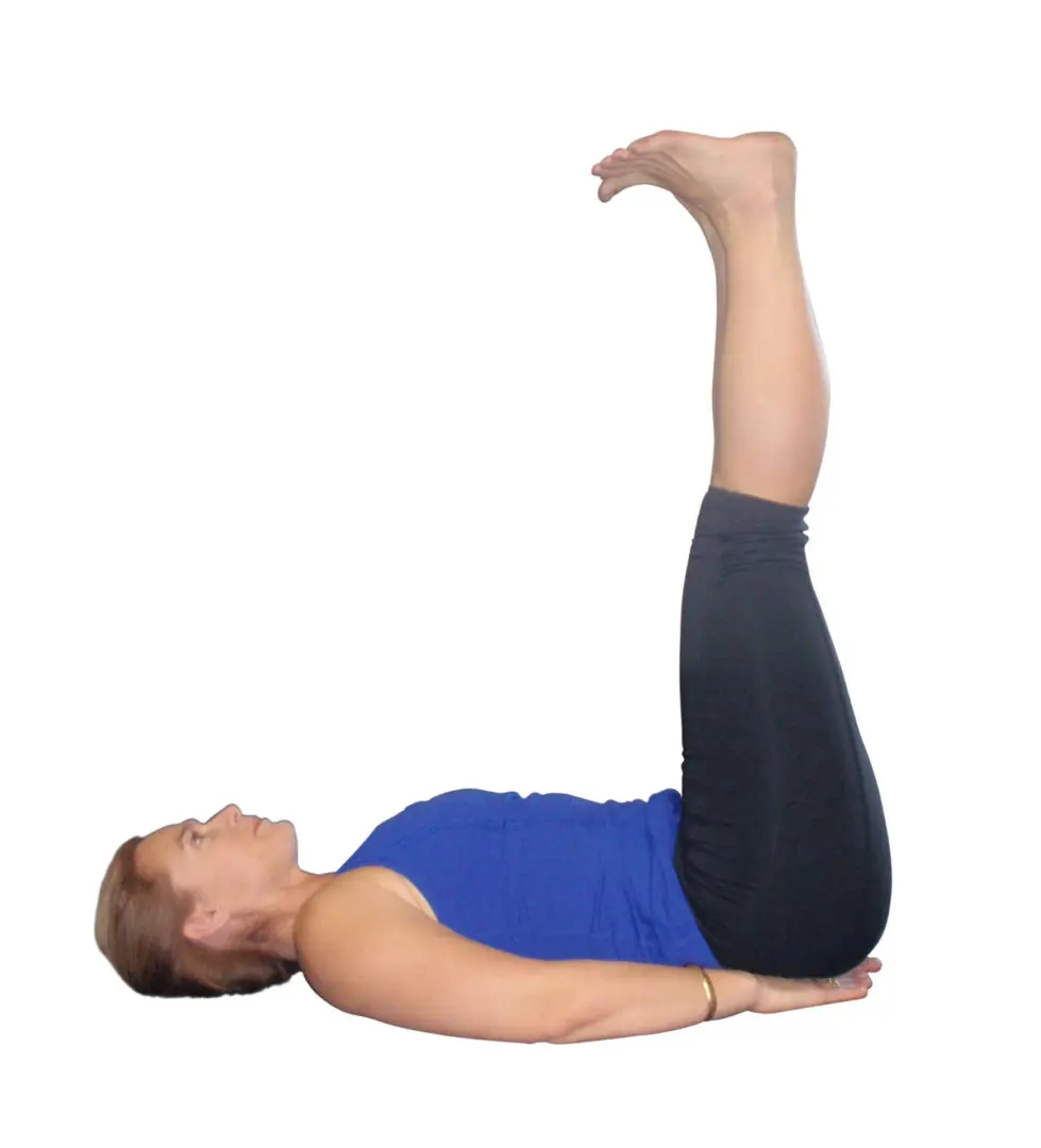 Woman doing a yoga pose with legs up.