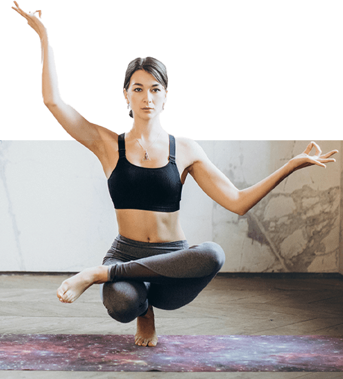 A woman in black top and leggings doing yoga.