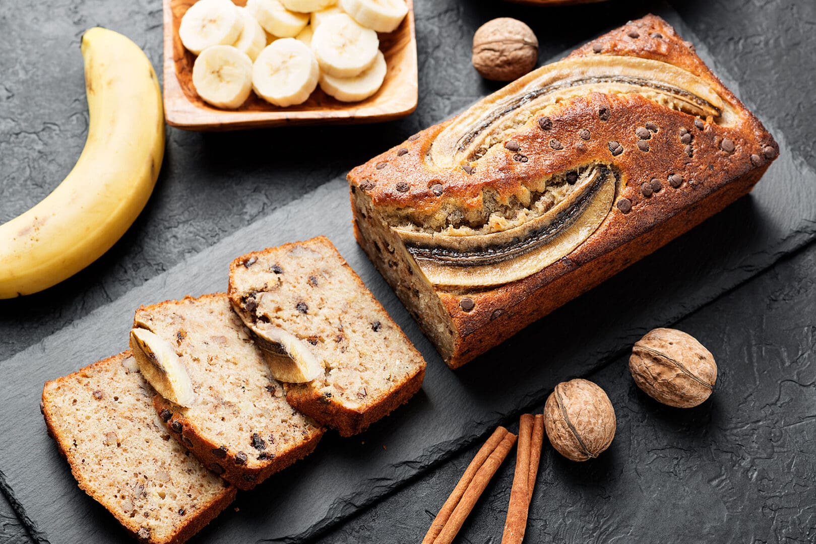 Banana bread with walnuts and cinnamon sticks.