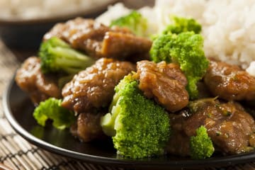 Beef with broccoli and rice on a plate.