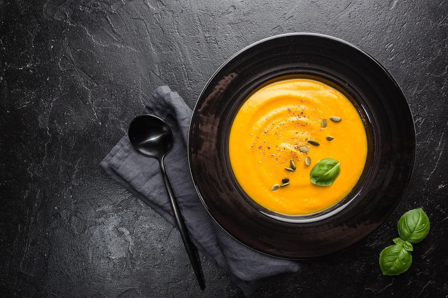 Pumpkin soup with seeds and basil.