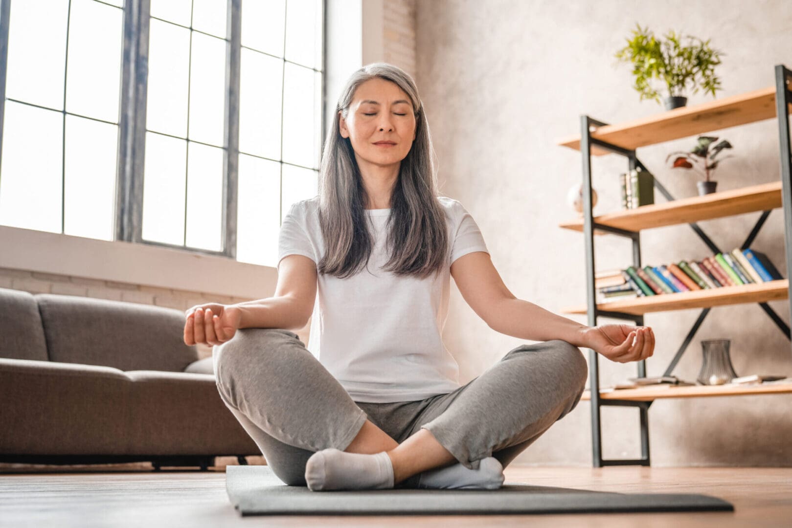 Woman meditating in a yoga pose.