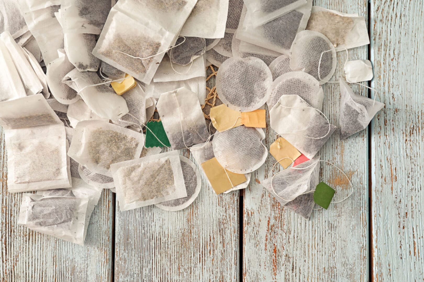 Used tea bags on a wooden table.