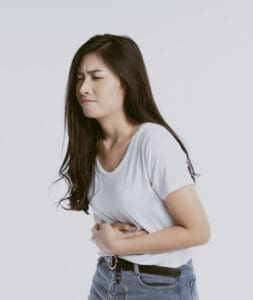 Woman holding stomach in pain.