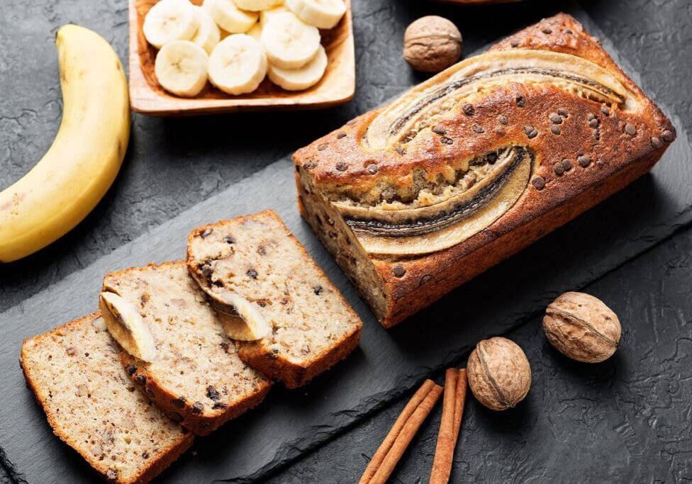 Banana bread with walnuts and cinnamon sticks.