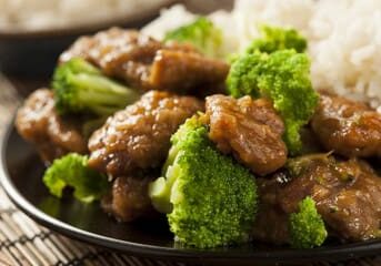 Beef with broccoli and rice on a plate.