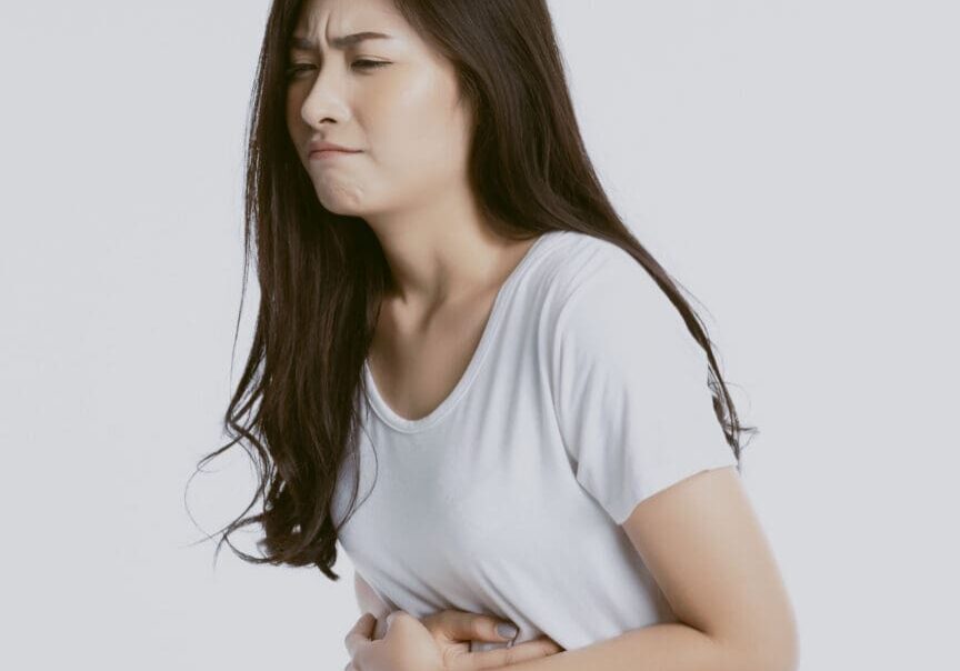 unhappy looking sick, suffers from stomach ache stomachache isolated white background because of menstruation and eating spoiled food, Chronic gastritis. Abdomen bloating concept