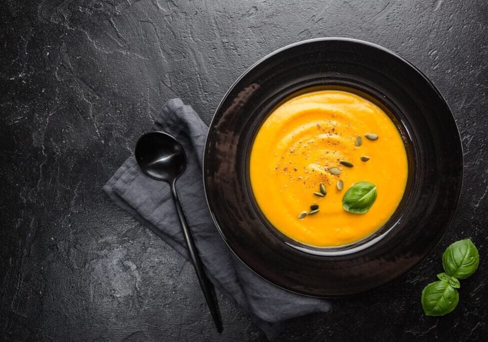 Pumpkin soup with seeds and basil.