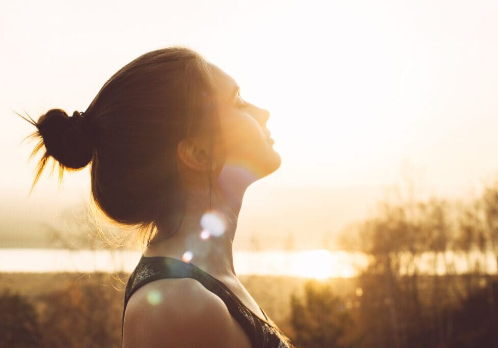 Close-up portrait of a pretty young woman in the sun