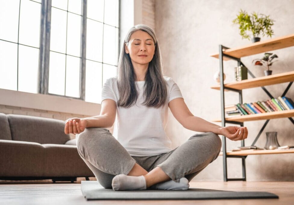 Woman meditating in a yoga pose.