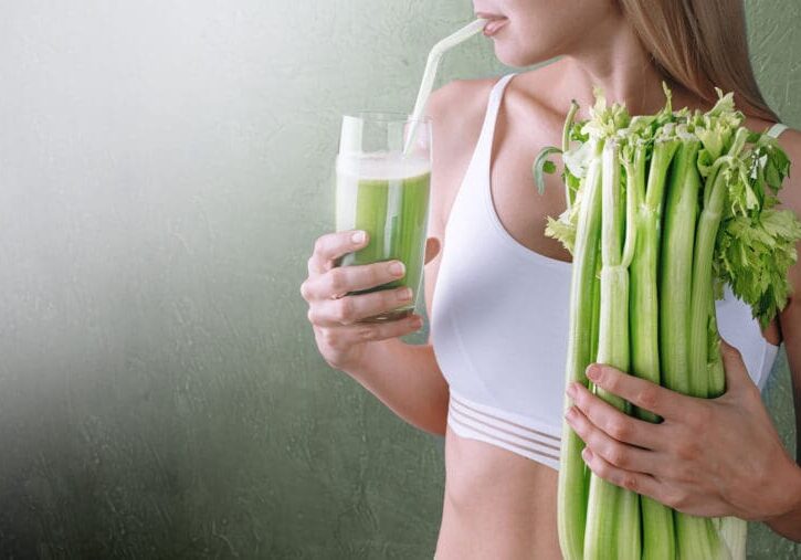 Woman drinking green celery juice.