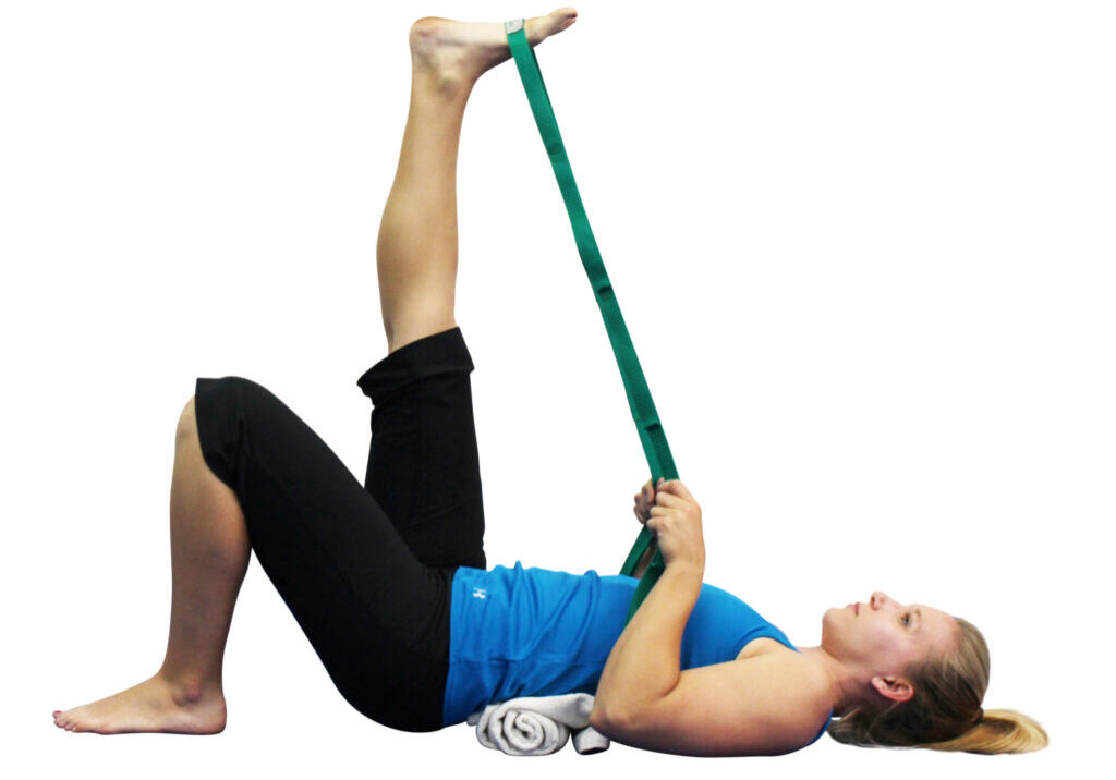 Woman stretching her leg with strap.