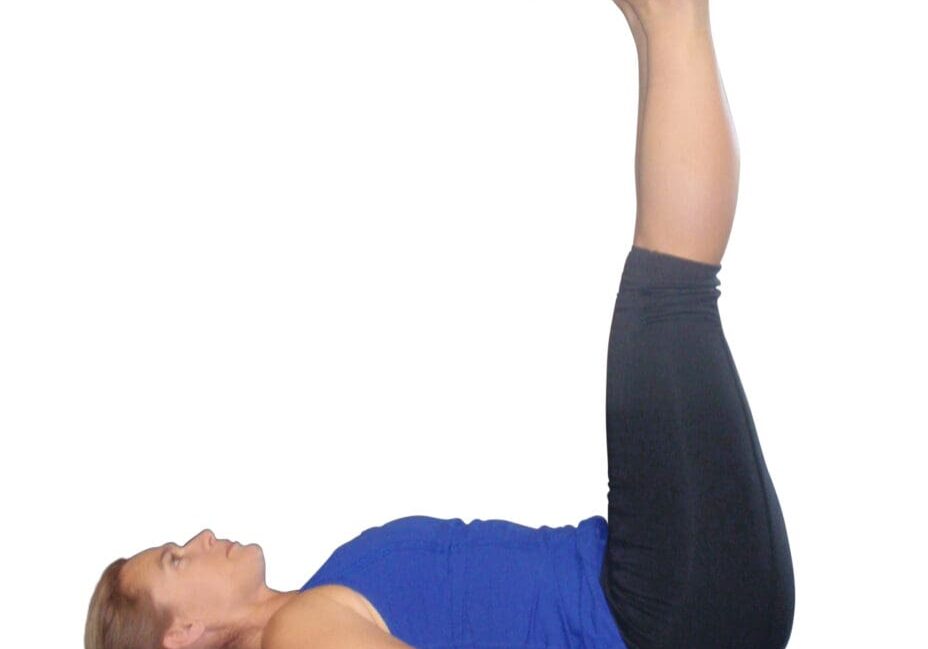 Woman doing a yoga pose with legs up.