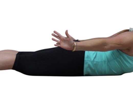 Woman in a yoga pose with arms extended.