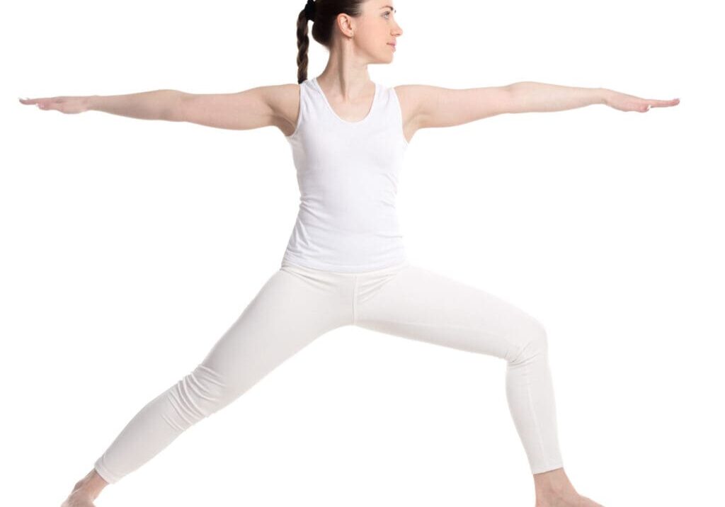 Woman in white doing a yoga pose.