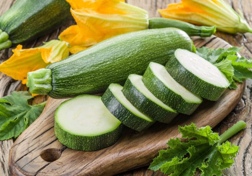 Sliced zucchini on a wooden board.